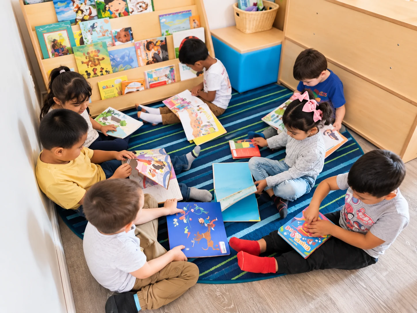 Preschool children enjoying books and early literacy together at Rosie’s